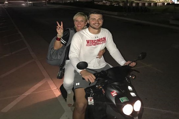 Jake Ferguson with his mom riding on a scooter